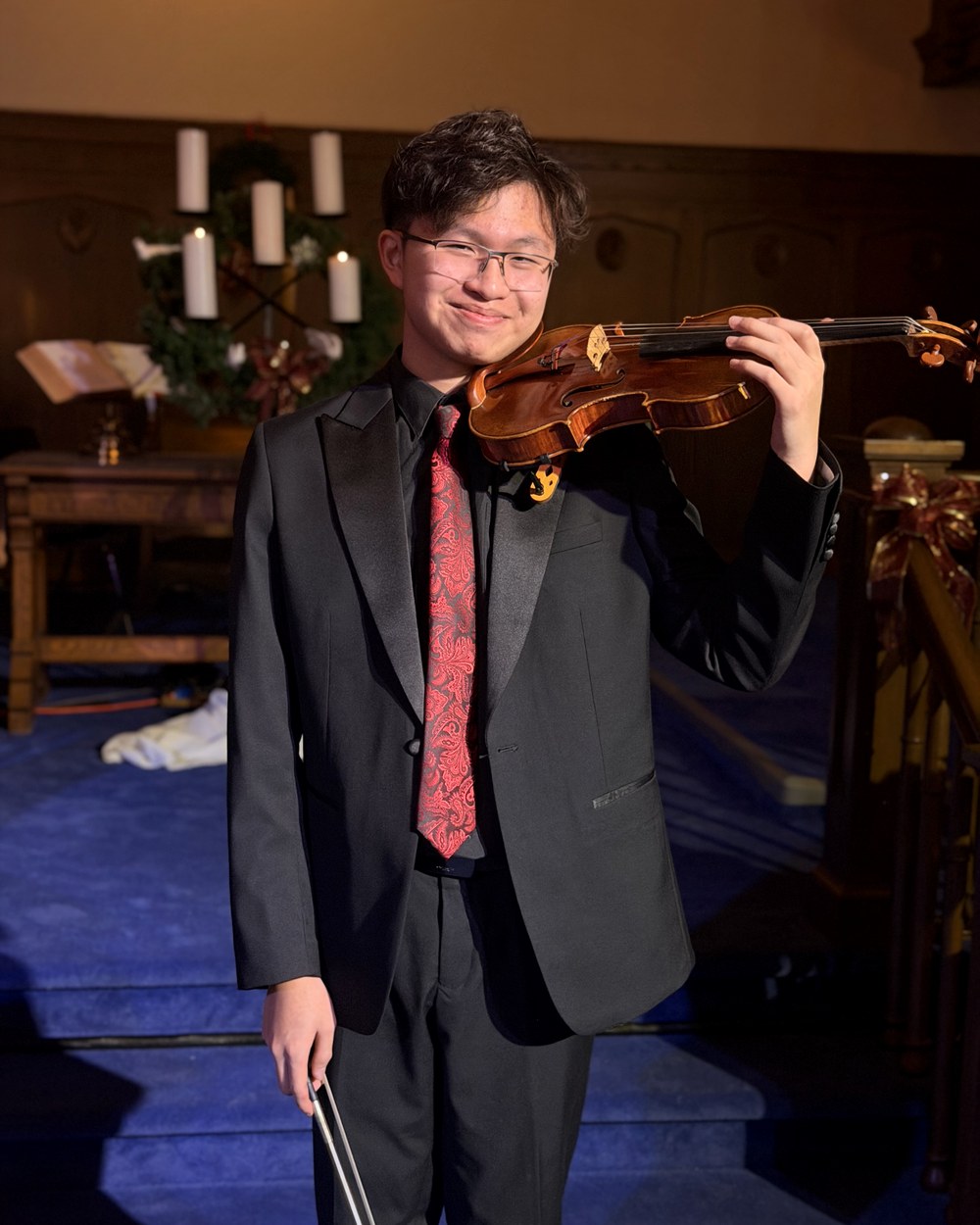 Vincent Pham smiling with his violin